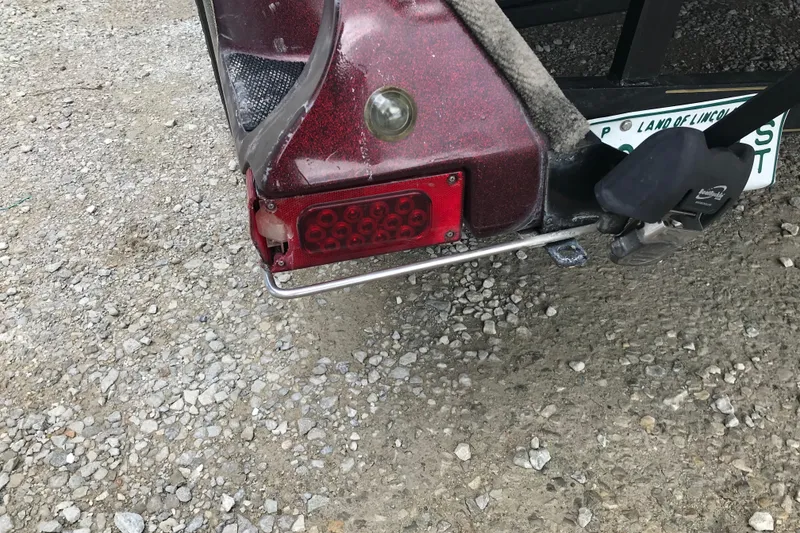 Slide: The Image of Rear view of a 2001 Ranger 518DVX Comanche trailer light on gravel. - 42