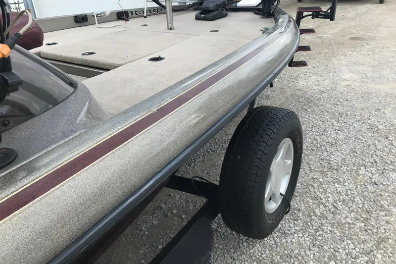 Slide: The Image of 2001 Ranger 518DVX Comanche boat on trailer, showcasing deck and hull details. - 43