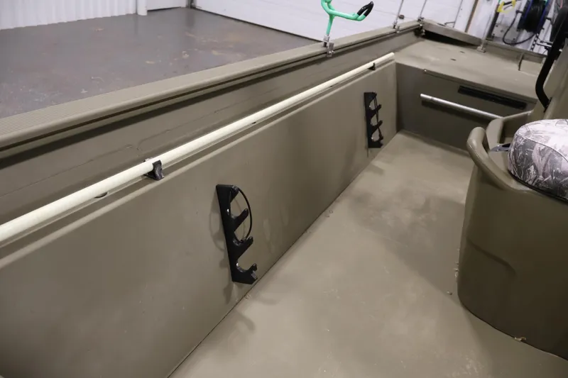 Slide: The Image of 2023 Tracker Grizzly 1860 MVX CC interior with rod holders and seating. - 16