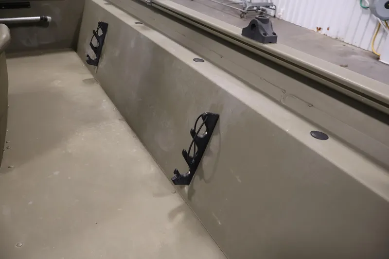 Slide: The Image of Interior view of 2023 Tracker Grizzly 1860 MVX CC boat, featuring rod holders. - 17