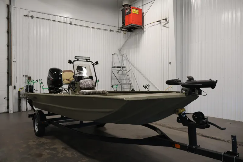 Slide: The Image of 2023 Tracker Grizzly 1860 MVX CC boat in a garage setting. - 2