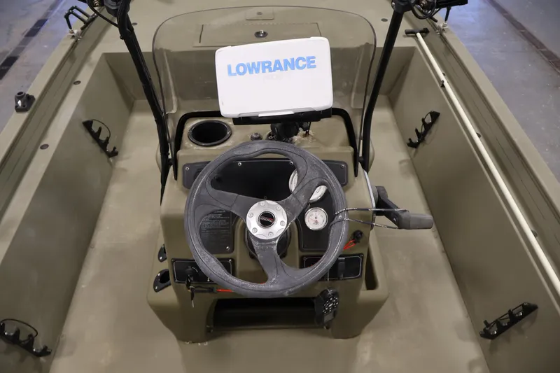 Slide: The Image of 2023 Tracker Grizzly 1860 MVX CC boat interior with steering wheel and Lowrance display. - 22