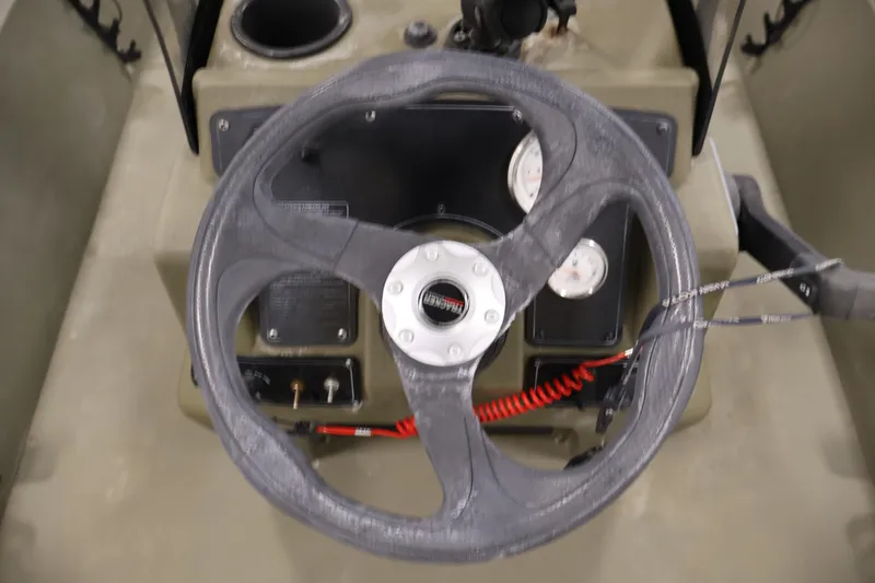 Slide: The Image of Steering wheel and dashboard of 2023 Tracker Grizzly 1860 MVX CC boat. - 23