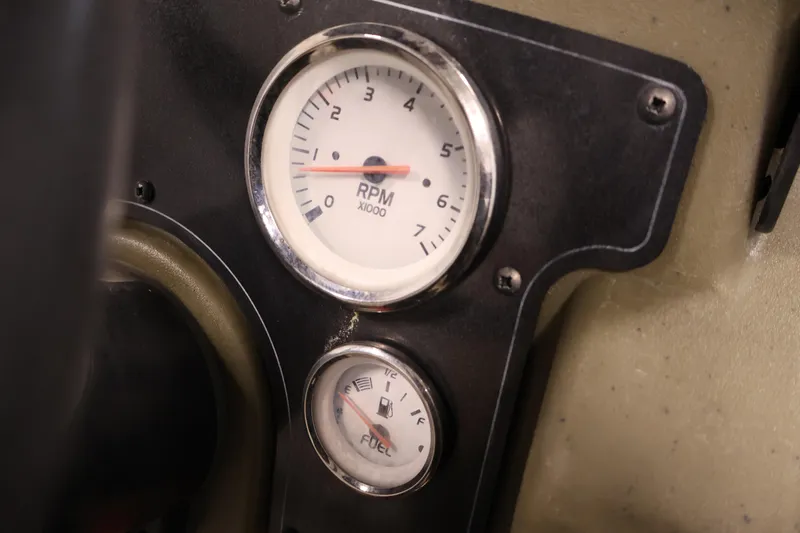 Slide: The Image of RPM and fuel gauges on 2023 Tracker Grizzly 1860 MVX CC dashboard. - 26