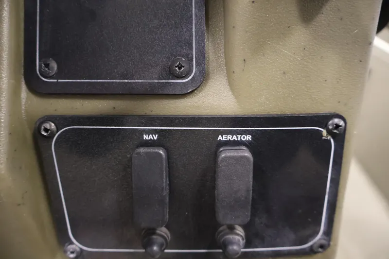 Slide: The Image of Control panel of 2023 Tracker Grizzly 1860 MVX CC with NAV and Aerator switches. - 27