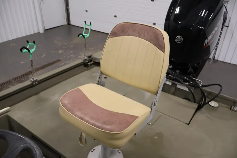 Slide: The Image of 2023 Tracker Grizzly 1860 MVX CC boat interior with beige seat and Mercury engine. - 29