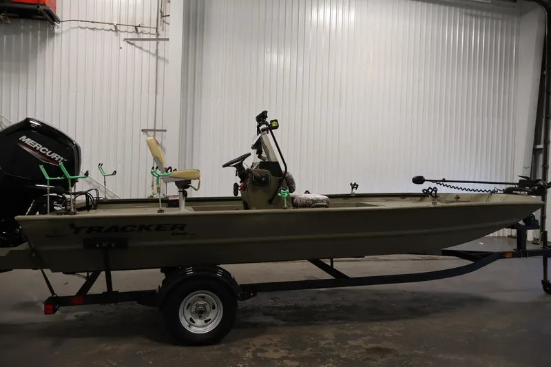 Slide: The Image of 2023 Tracker Grizzly 1860 MVX CC boat in a garage setting. - 3