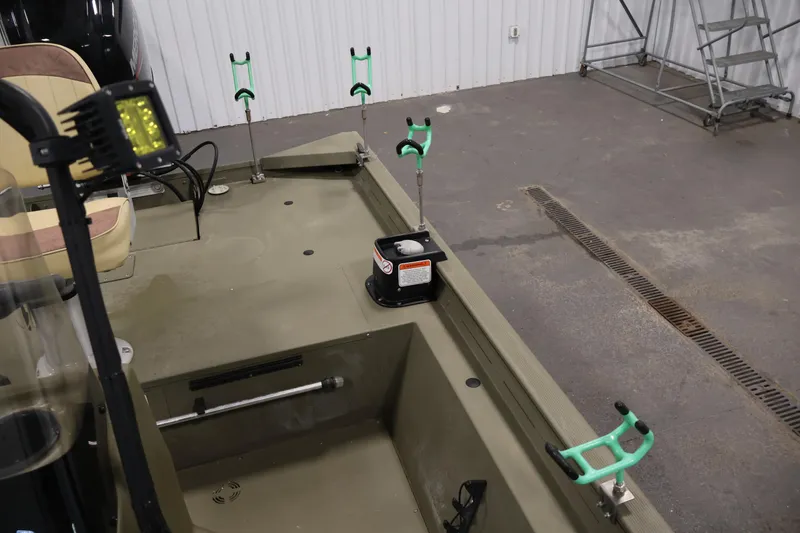 Slide: The Image of 2023 Tracker Grizzly 1860 MVX CC boat interior with rod holders and seating. - 31