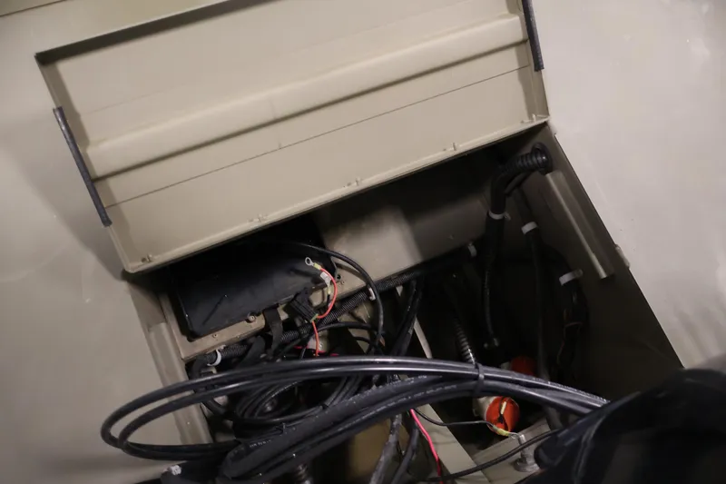 Slide: The Image of 2023 Tracker Grizzly 1860 MVX CC boat wiring and storage compartment. - 32