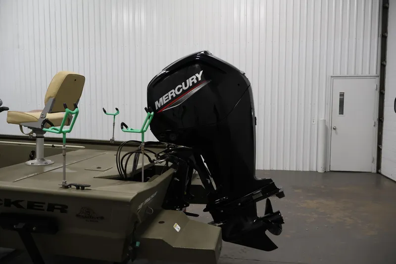 Slide: The Image of 2023 Tracker Grizzly 1860 MVX CC boat with Mercury outboard motor in a garage setting. - 33