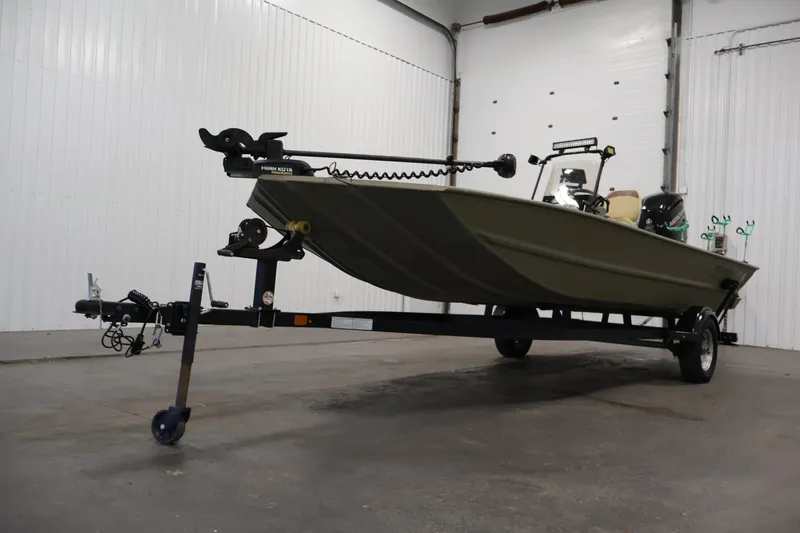 Slide: The Image of 2023 Tracker Grizzly 1860 MVX CC boat on trailer in indoor setting. - 38