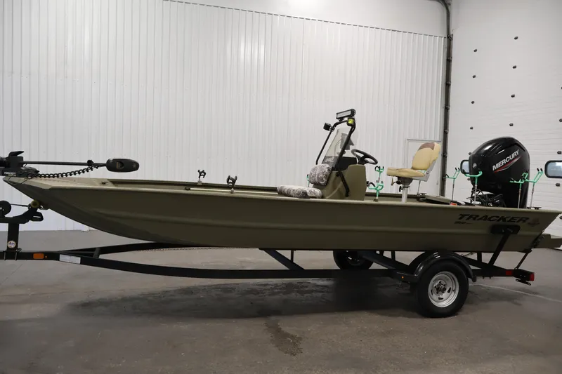 Slide: The Image of 2023 Tracker Grizzly 1860 MVX CC boat on trailer in indoor setting. - 7