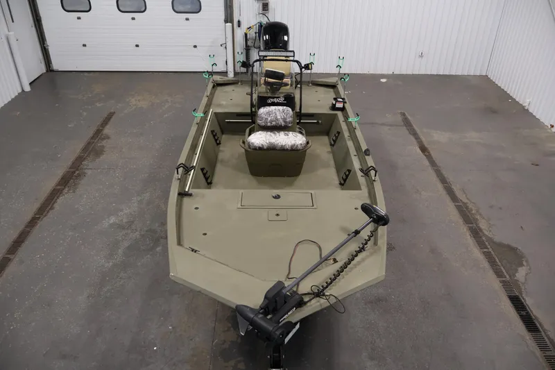 Slide: The Image of 2023 Tracker Grizzly 1860 MVX CC boat in a garage, top view. - 8