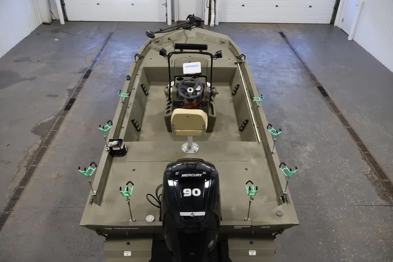 Slide: The Image of 2023 Tracker Grizzly 1860 MVX CC boat with Mercury 90 engine in a garage. - 9