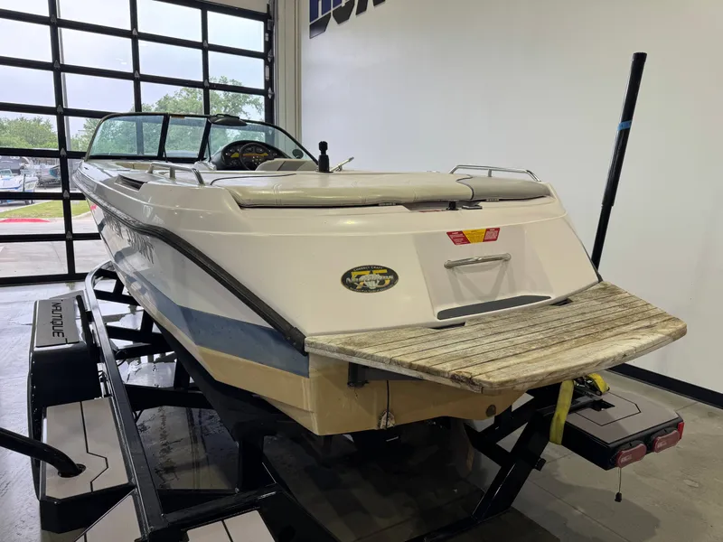 Slide: The Image of 2000 Nautique Super Sport 210 boat in a garage. - 4