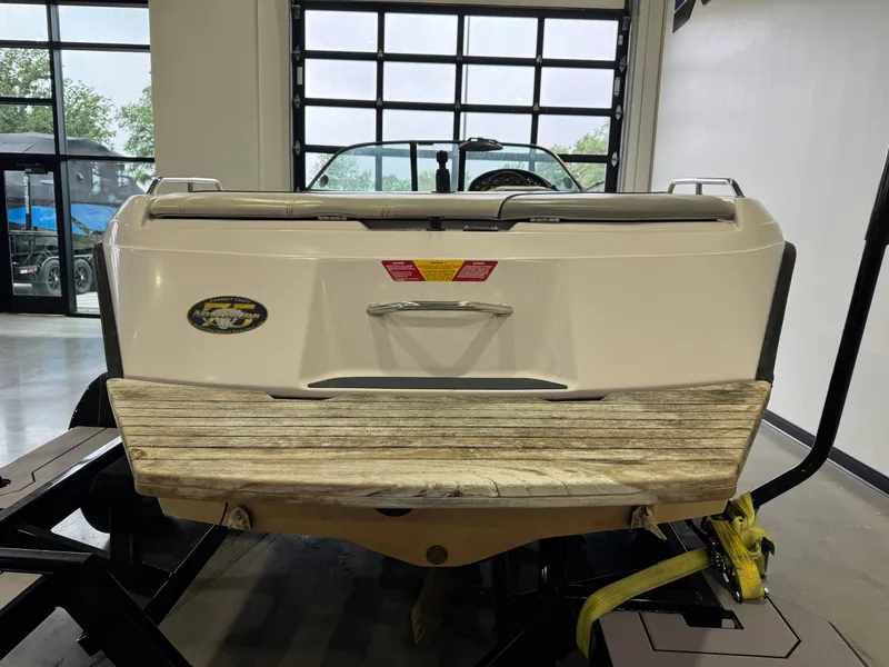 Slide: The Image of Rear view of a 2000 Nautique Super Sport 210 boat in a garage. - 5