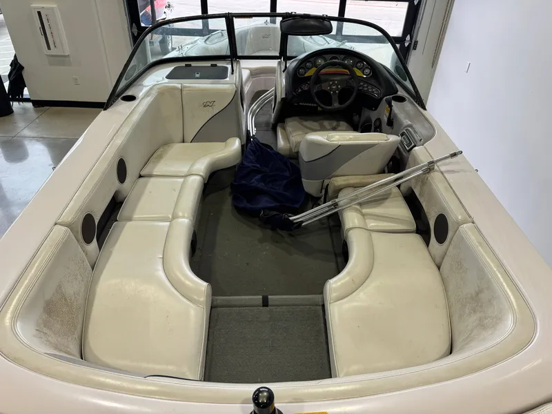 Slide: The Image of Interior of a 2000 Nautique Super Sport 210 boat with white seating. - 8