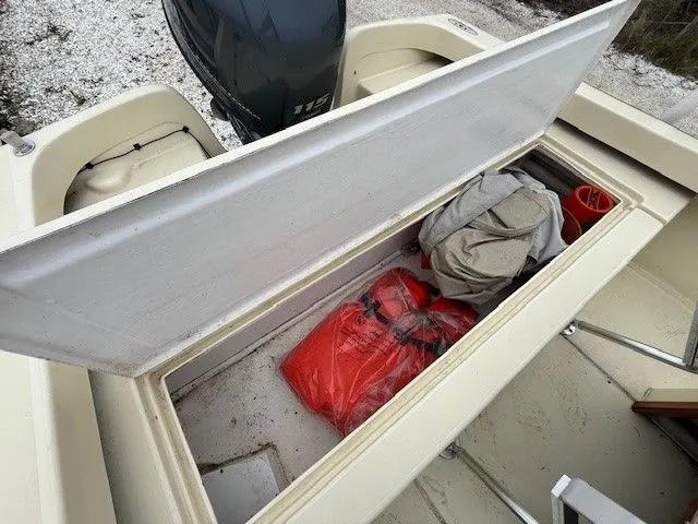 Slide: The Image of Roth Bilt 18 boat 2022 with open storage compartment and gear. - 13