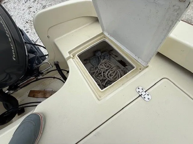 Slide: The Image of Roth Bilt 18 boat 2022 with open storage compartment and rope. - 15