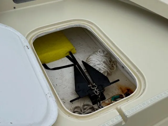 Slide: The Image of Anchor compartment of Roth Bilt 18 boat with rope and sponge. - 17