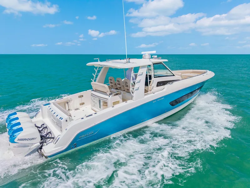 Slide: The Image of 2018 Boston Whaler 420 Outrage cruising on open sea, blue and white yacht. - 1