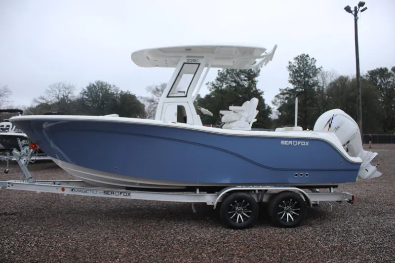 Slide: The Image of 2026 Sea Fox 228 Commander boat on trailer, side view, blue hull, outdoor setting. - 3