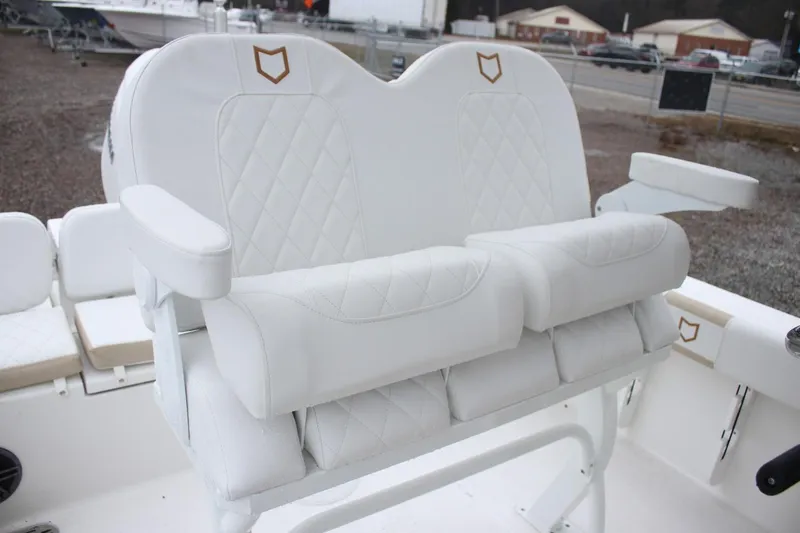 Slide: The Image of White cushioned seating on 2026 Sea Fox 228 Commander boat, featuring diamond stitching. - 5