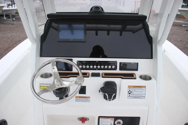 Slide: The Image of 2026 Sea Fox 228 Commander boat dashboard with steering wheel and electronic controls. - 8