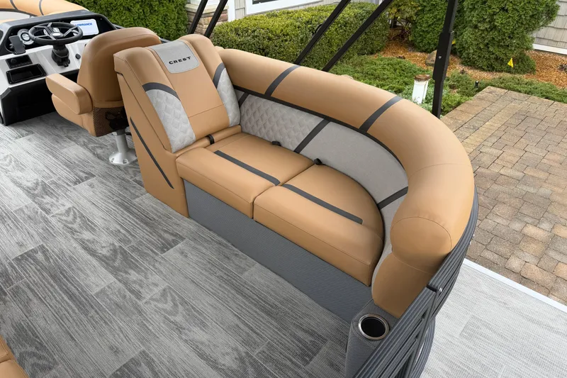 Slide: The Image of Luxurious seating on 2025 Crest Classic 220 boat, featuring tan and gray upholstery. - 12