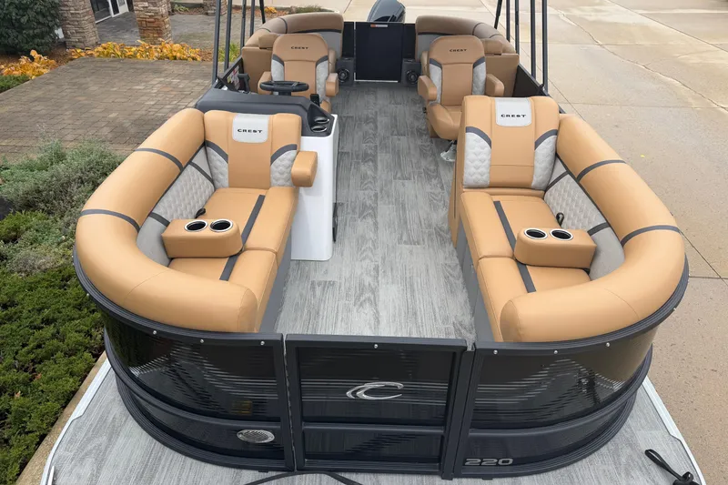 Slide: The Image of 2025 Crest Classic 220 pontoon boat with tan seating and modern design. - 2