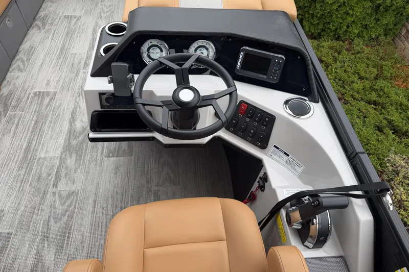 Slide: The Image of Steering console of 2025 Crest Classic 220 boat with modern controls and tan seating. - 7