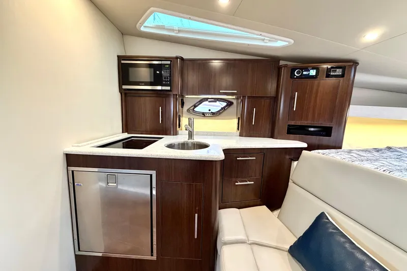 Slide: The Image of Luxurious interior of 2017 Regal 35 Sport Coupe yacht with modern kitchenette. - 11