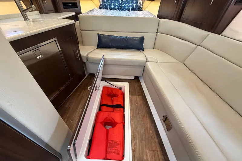 Slide: The Image of Interior of 2017 Regal 35 Sport Coupe with storage compartment and life jackets. - 14