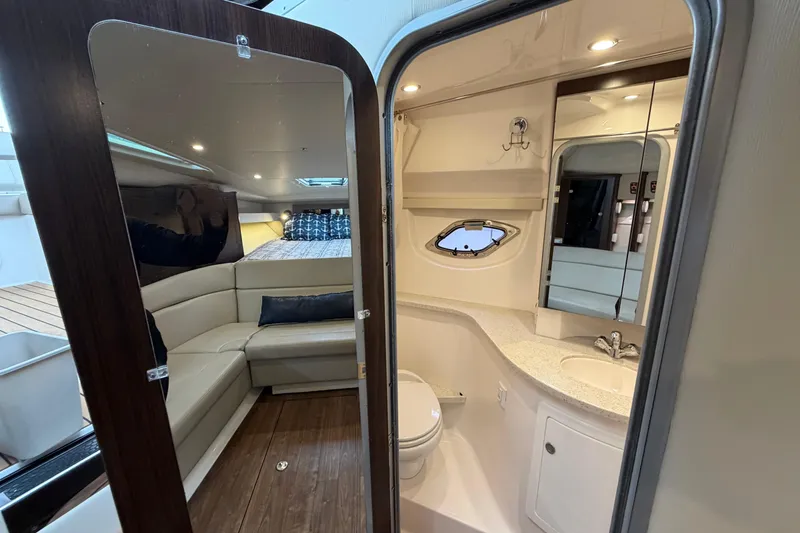 Slide: The Image of Interior of 2017 Regal 35 Sport Coupe, featuring a cozy cabin and modern bathroom. - 17