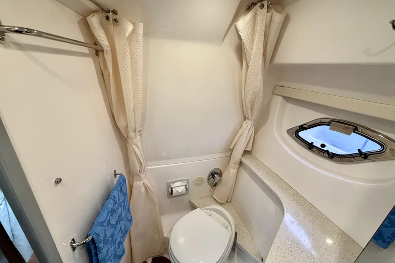 Slide: The Image of Bathroom interior of 2017 Regal 35 Sport Coupe with porthole and shower curtain. - 18