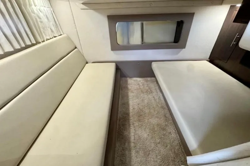 Slide: The Image of Interior cabin of 2017 Regal 35 Sport Coupe with beige seating and carpet. - 26