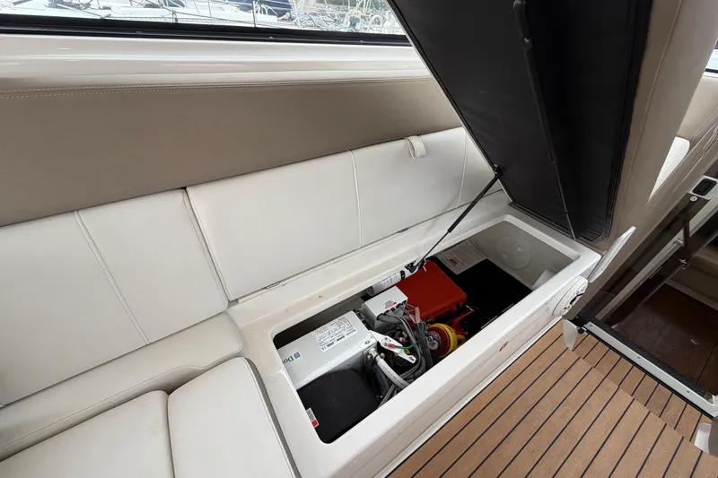 Slide: The Image of 2017 Regal 35 Sport Coupe interior storage compartment with open seat revealing equipment. - 29