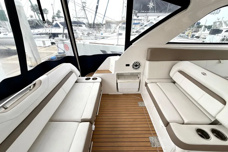 Slide: The Image of Interior of a 2017 Regal 35 Sport Coupe with white seating and wooden flooring. - 30