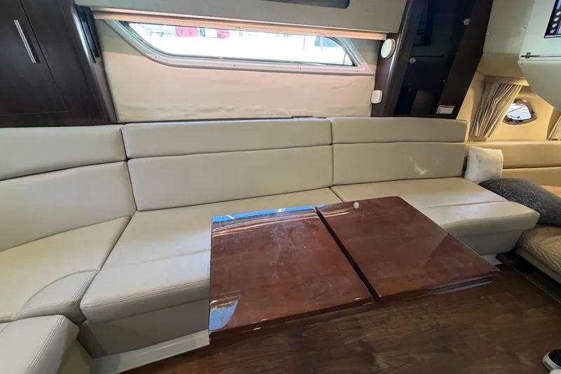 Slide: The Image of Luxurious interior of a 2017 Regal 35 Sport Coupe with beige seating and wooden table. - 34