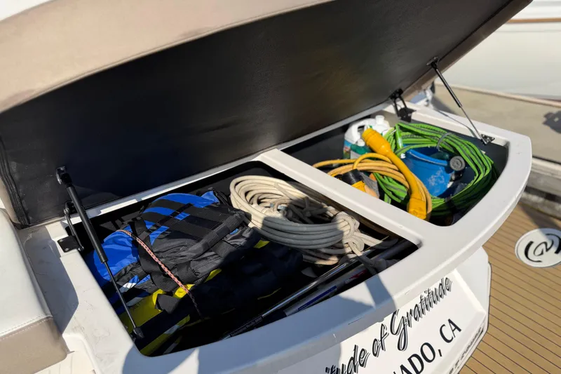 Slide: The Image of Open storage compartment on 2017 Regal 35 Sport Coupe with boating gear and equipment. - 48