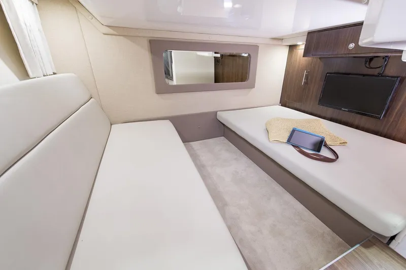 Slide: The Image of Manufacturer Provided Image: Interior cabin of 2017 Regal 35 Sport Coupe with beige seating and wall-mounted TV. - 6
