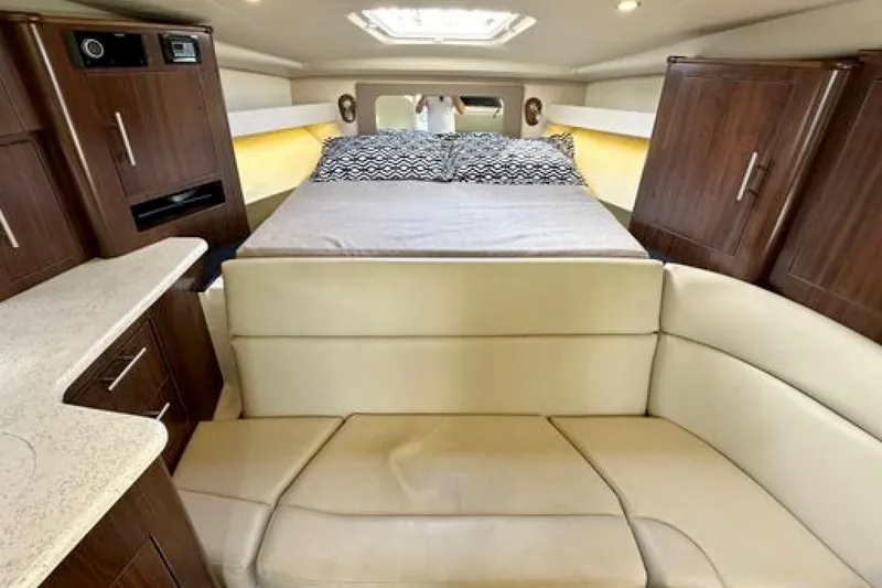 Slide: The Image of Interior of 2017 Regal 35 Sport Coupe with bed, seating, and wood cabinetry. - 8