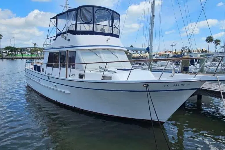 The Image of 1988 Overseas Monk 42 yacht docked in marina, featuring spacious upper deck. - 0