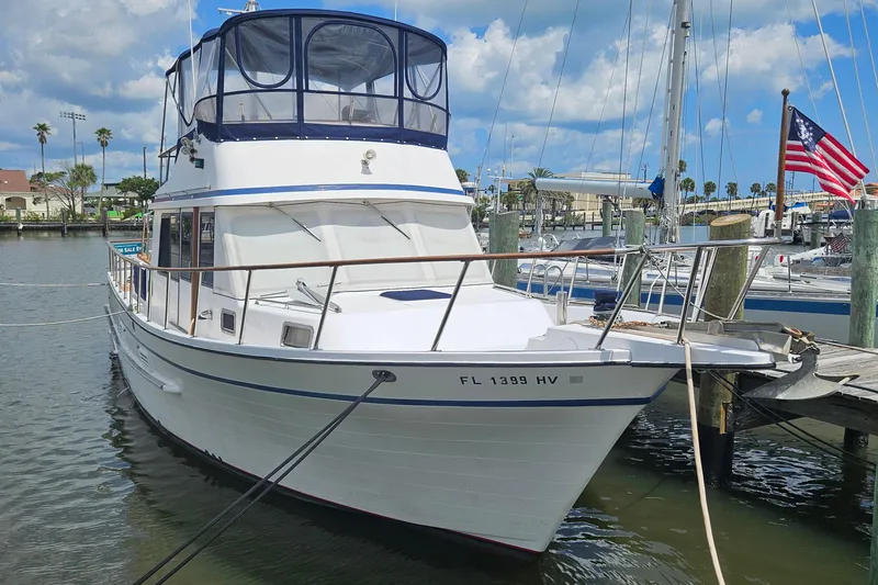 Slide: The Image of 1988 Overseas Monk 42 yacht docked at marina with clear skies. - 101