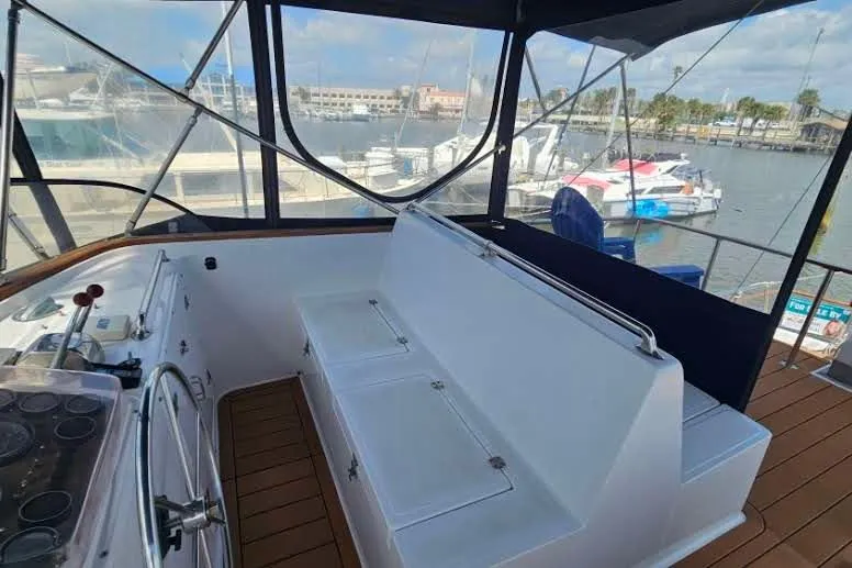 Slide: The Image of 1988 Overseas Monk 42 yacht interior with helm and seating, docked at marina. - 15