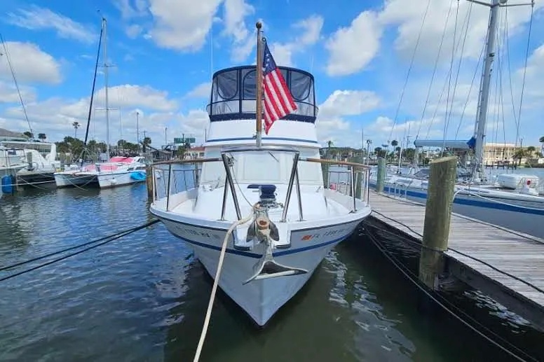 Slide: The Image of 1988 Overseas Monk 42 yacht docked at marina, featuring spacious deck and flybridge. - 2