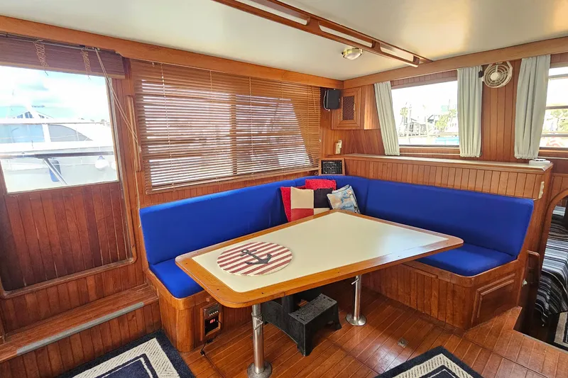 Slide: The Image of Interior of 1988 Overseas Monk 42 yacht with blue seating and nautical-themed decor. - 22