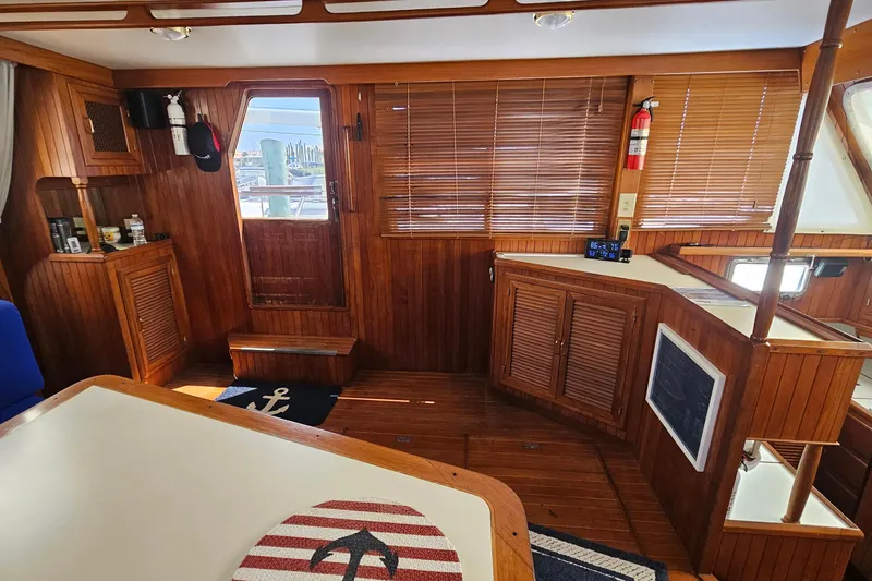 Slide: The Image of Interior of 1988 Overseas Monk 42 yacht with wooden paneling and nautical decor. - 24