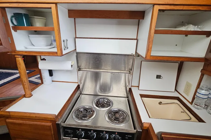 Slide: The Image of Compact kitchen in 1988 Overseas Monk 42 boat with stove, sink, and storage cabinets. - 35