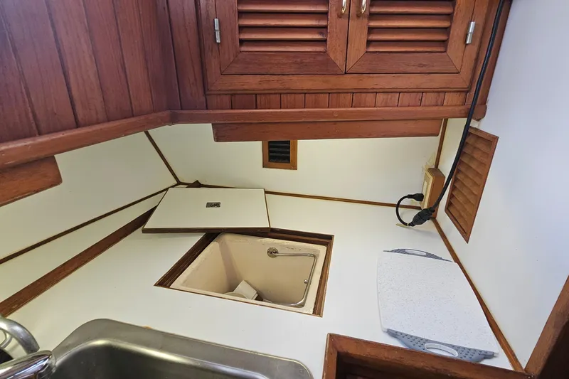 Slide: The Image of Galley area of 1988 Overseas Monk 42 boat with wooden cabinets and sink. - 45